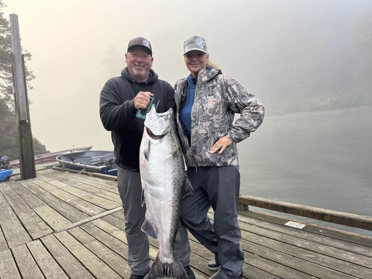 Guests on the Siletz River dock with a bright fall Chinook salmon
