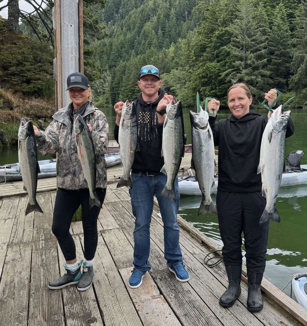 Three anglers on the dock with a limit of Oregon Coast salmon