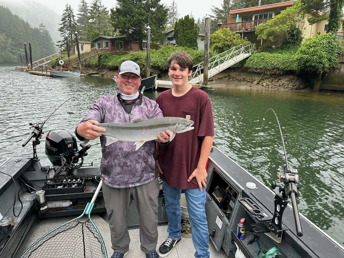 Father and son with a bright Siletz River steelhead