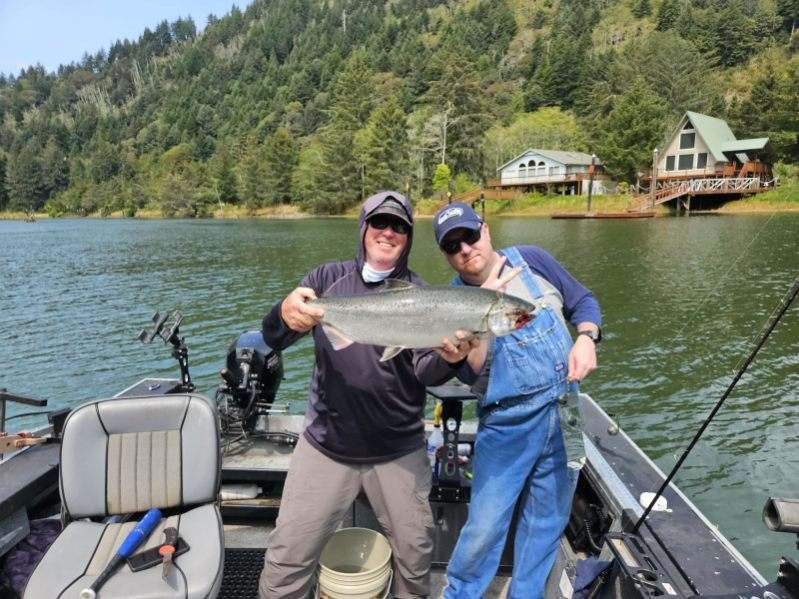 Pair of anglers with two Oregon Coast salmon at the boat